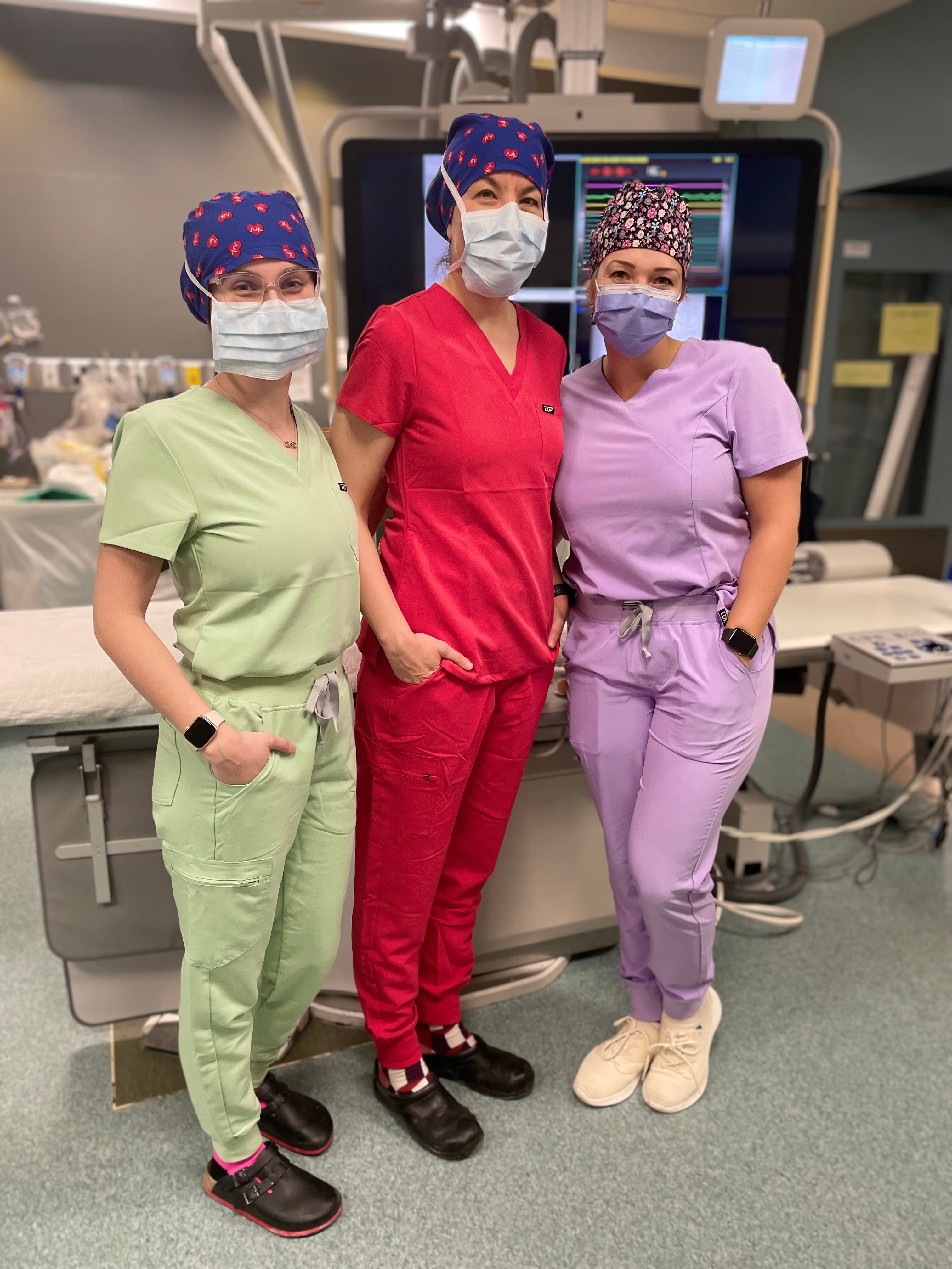 three women in lux scrubs.mint green, red and light purple scrub sets