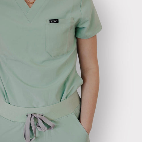 Lux Scrubs Sage Green Scrub Top. One chest pocket. 2 lower front pockets