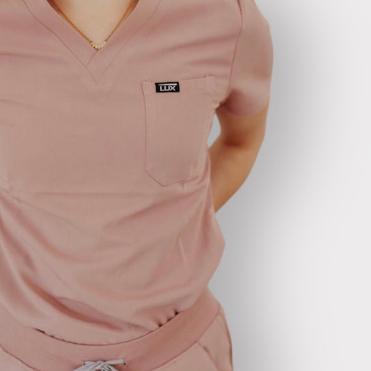 Lux Scrubs Blush Pink Scrub Top. One chest pocket, two lower pockets on top. 