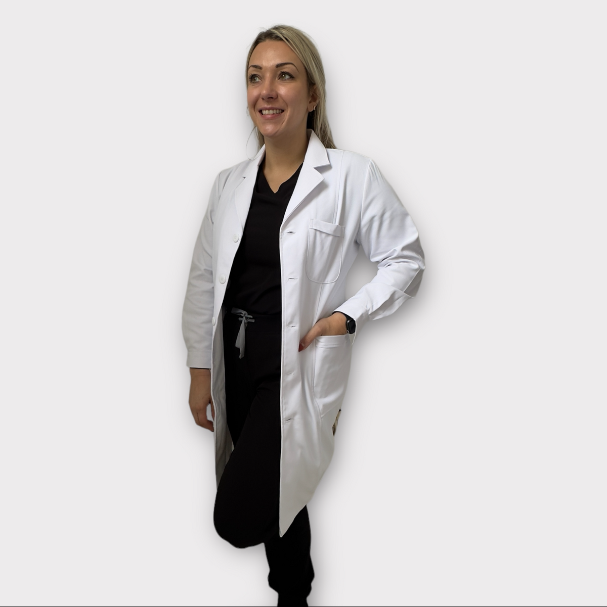 Person wearing a white lab coat on a plain background