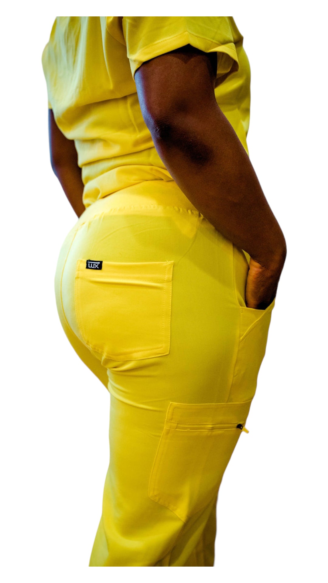 A person wearing yellow women's scrub joggers with multiple pockets and an adjustable drawstring waistband.